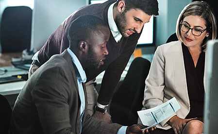 group of professionals reviewing document
