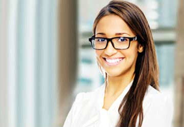 woman with glasses smiling at camera