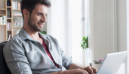 man working on laptop at a desk