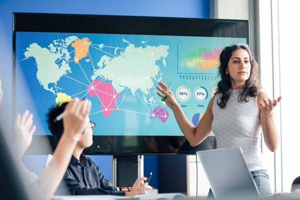 A woman gives a presentation about a company’s international business