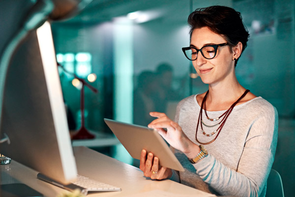 A woman looks at a laptop