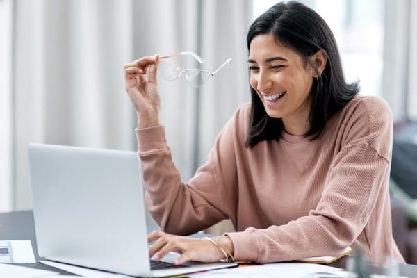 Online college student chatting and laughing on a video call
