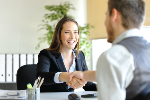 A woman shakes a man's hand