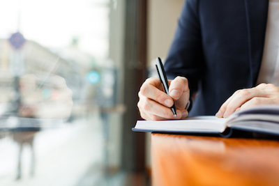 A student writes in a notebook.