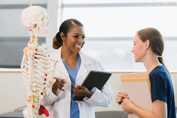 A health educator works with a student in a classroom.