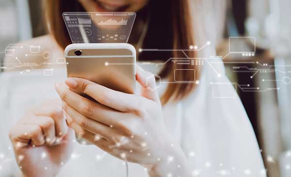 A woman holds a mobile phone