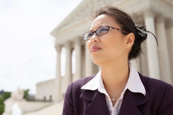A woman faces the future of politics in front of a government building.