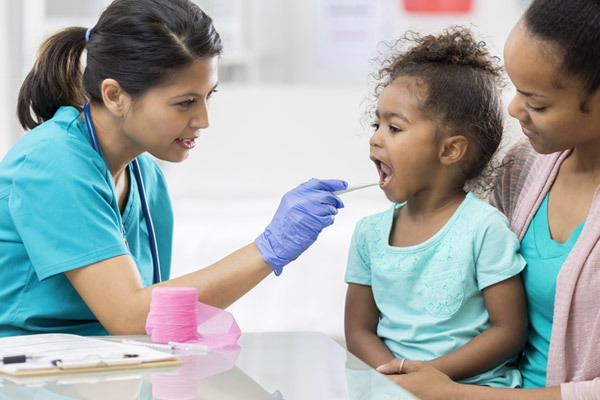 A nurse examines a child