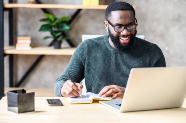 A man takes a competency-based degree course online.