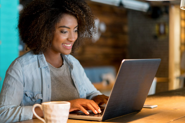 A woman looks at a laptop