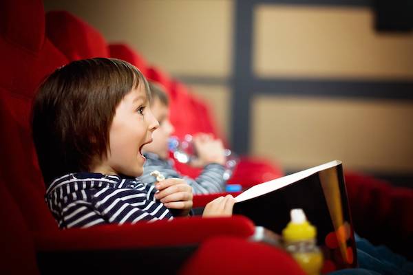 A child sits in a movie theater