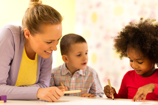 A teacher works with two students