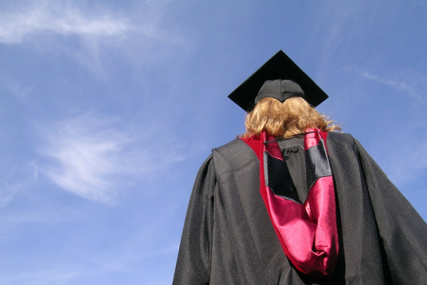 Woman in graduate robes and master’s hood