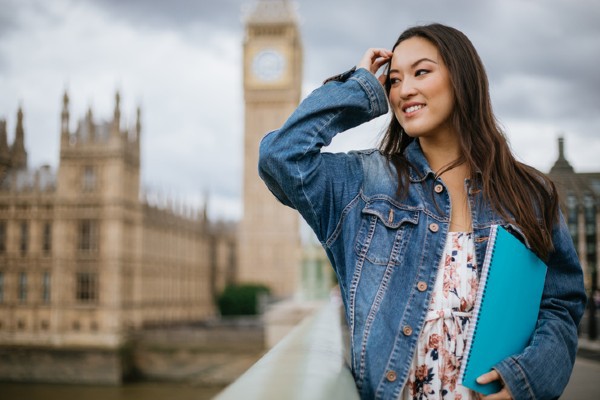 A female student pauses to view Big Ben in London.