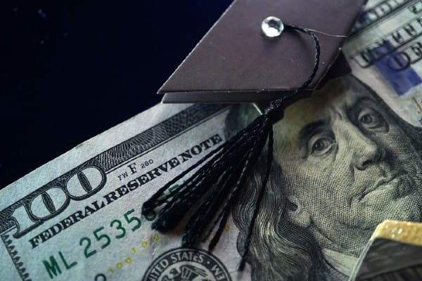 A $100 bill with a graduation cap