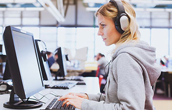 Women with headset working at computer