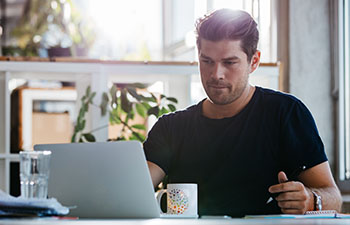 Man working on a laptop at home