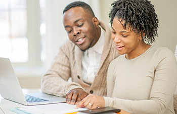 African-American couple working on documents