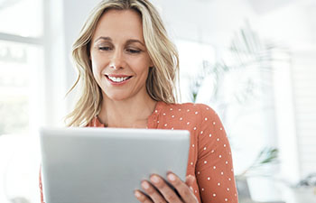 Smiling woman holding a tablet computer