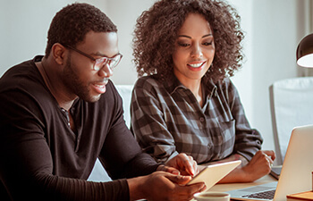 man and woman working on a laptop