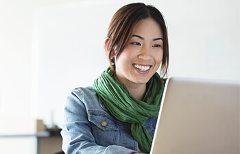 smiling woman working on laptop