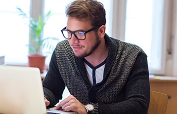 Male student working on a laptop